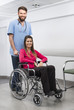 © Tyler Olson - Female Patient Sitting In Wheelchair While Nurse Standing At Hos