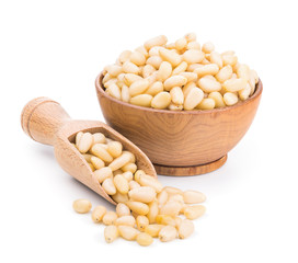 Wall Mural - Pine nuts in a wooden bowl isolated on white