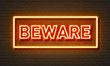 Beware neon sign on brick wall background.
