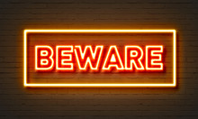 Beware Neon Sign On Brick Wall Background.