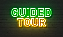 Guided Tour Neon Sign On Brick Wall Background.