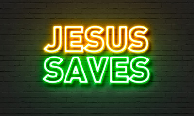 Wall Mural - Jesus saves neon sign on brick wall background.