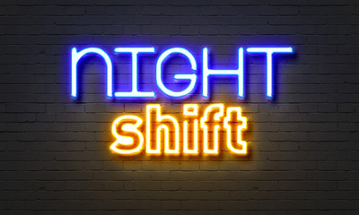 Wall Mural - Night shift neon sign on brick wall background.