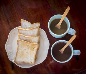 Breakfast time with two coffee and bread