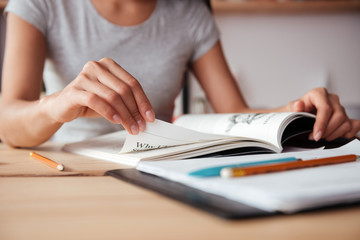 Sticker - Cropped image of young woman reading magazine.