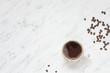 Cup of coffee on a marble surface with copy-space