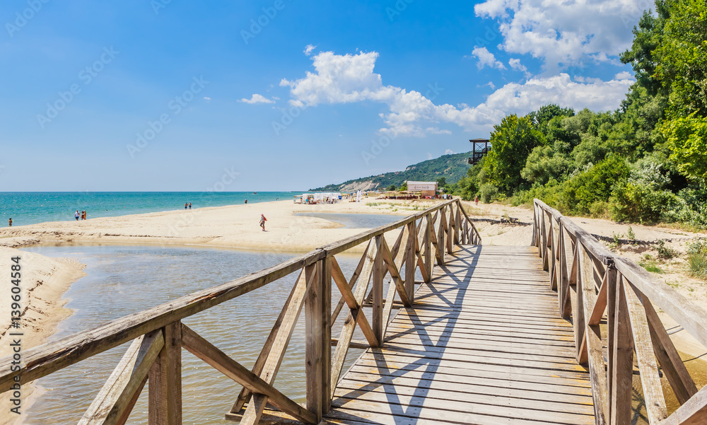 Wooden footbridge over the river. Black Sea Coast,  seaside resort Albena, Bulgaria - obrazy, fototapety, plakaty 