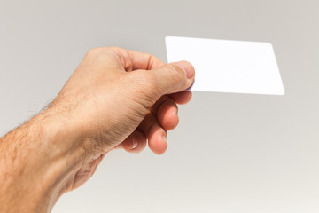 Male hand with white empty card