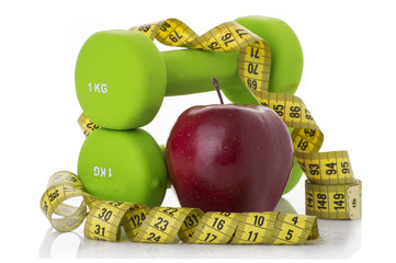 Two dumbbells, red apple, measuring tape.