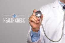 Doctor Holding A Stethoscope And Word "HEALTH CHECK" On Gray Background. Concept Healthy.