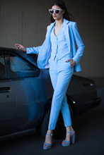 Mafia Lady Outside Japonese Car In The Sea Port. Fashion Girl Standing Next To A Retro Sport Car On The Sun. Stylish Woman In A Blue Suit And Sunglasses Waiting Near Classic Car.