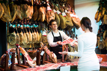 Wall Mural - Female customer buying Spanish jamon