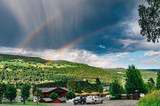 Fototapeta Tęcza - Double rainbow over norwegian landscape with camping