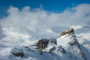 rock covered with snow and fog