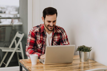 Handsome man working on his tasks from office