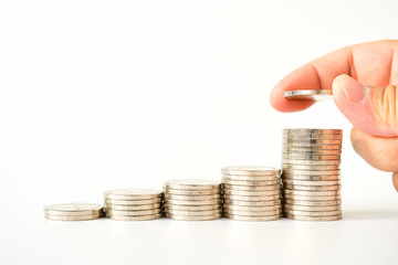 Money, Financial, Business Growth concept, stack of coins with Man's hand put money coins on white background with copyspace , Finance banking account and money currency saving background 