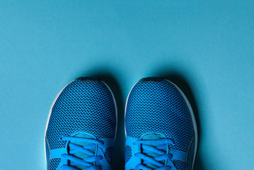 Wall Mural - One Pair of blue sport shoes on blue background.