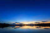 Fototapeta Niebo - Breathtaking sunset over lake with blue sky