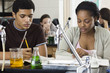 © PhotoAlto - Students completing assignment in chemistry class