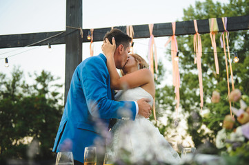 Wall Mural - Kissing Newlyweds at Table