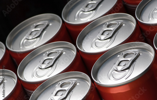 Fotografia group of red can tins close up on a black background