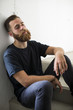 © juananbarros - Bearded man sitting on stairs.