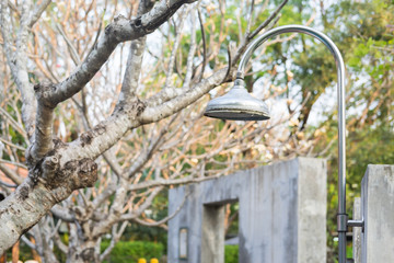 Outdoor shower sprinkler in the garden for swimming