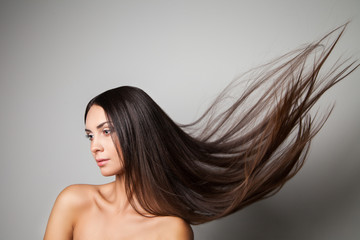  Young woman posing with her gorgeous long flying hair. 