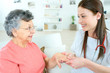 © auremar - Nurse inspecting elderly lady's hand