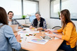 © W PRODUCTION - group of young cool hipster business people in casual wear working together in meeting room of a startup company