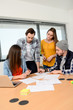© W PRODUCTION - group of young cool hipster business people in casual wear working together in meeting room of a startup company