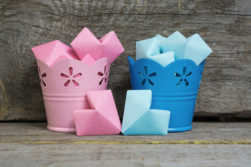 Paper hearts pink and blue color In decorative buckets Abstract symbol of man (boy) or woman (girl) 