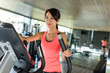 © leungchopan - Woman training on Elliptical machine