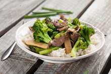 Beef N’ Broccoli Stir Fry On Light Weathered Wood With Green Beans To Side Horizontal Shot