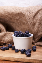 Wall Mural - Pot of blueberries on a rustic background