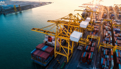 container ship in import export and business logistic.By crane ,Trade Port , Shipping.cargo to harbor.Aerial view.Top view.