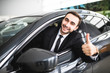 © F8  \ Suport Ukraine - Businessman smiling at camera showing thumbs up in his car
