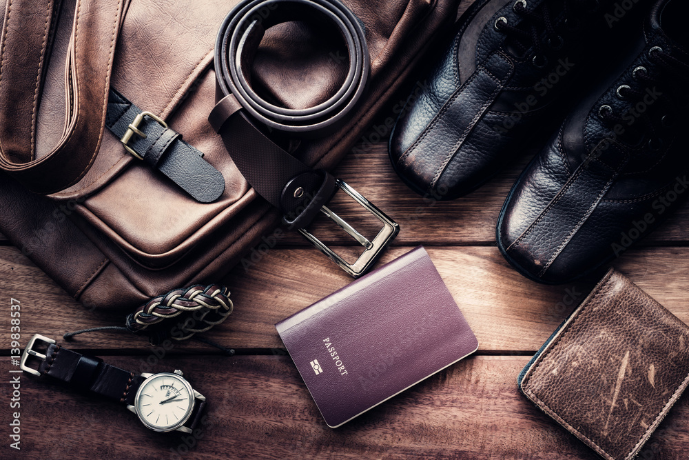Still life with Men's casual outfits with leather accessories on brown wooden background, beauty and fashion, travel concept - obrazy, fototapety, plakaty 