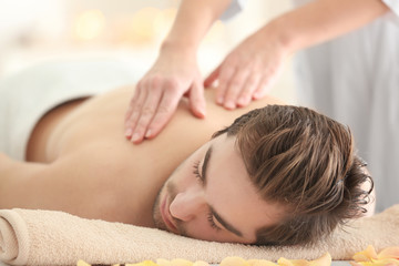 Poster - Young man having massage in spa salon