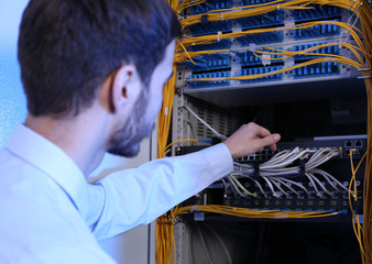 Handsome young engineer in server room