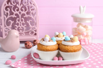 Wall Mural - Plate with delicious Easter cupcakes on table