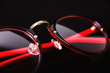 Fashion red black eye glasses isolated on black background