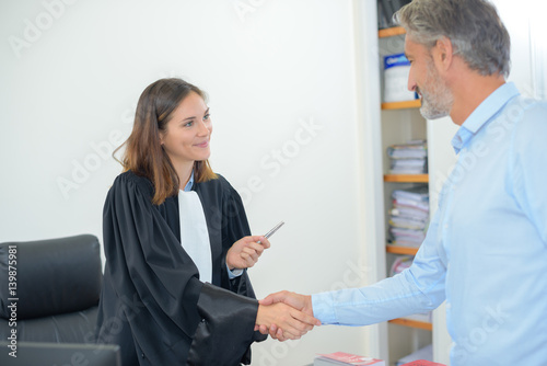 Fotografie, Tablou Female magistrate shaking hands with man