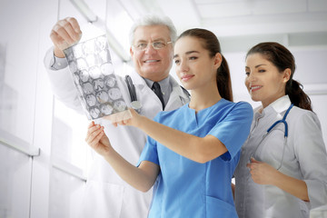 Sticker - Group of doctors looking at roentgenogram in clinic