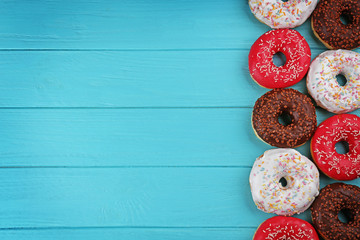 Wall Mural - Glazed donuts on wooden background