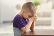 © Africa Studio - Cute little boy praying at home