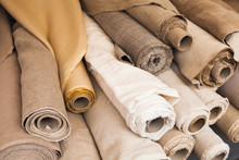 Rolls Of  Linen Cloth Lie On Counter