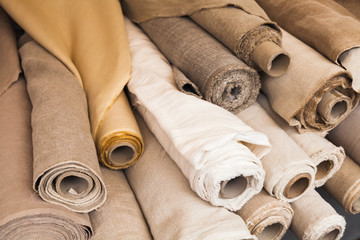 Rolls of  linen cloth lie on counter