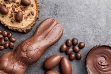 Chocolate Easter bunny and eggs on wooden background