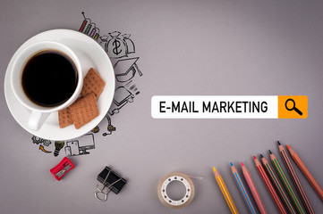 Wall Mural - e-mail marketing concept. Gray office desk with the inscription.